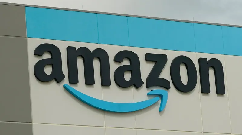 Amazon logo on a digital screen with stock market graphs