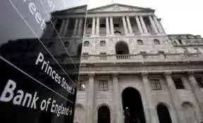 Bank of England building with economic charts overlay