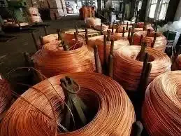 Copper and aluminium bars stacked in a warehouse
