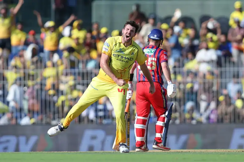 Chennai Super Kings players strategizing on the field during an IPL match