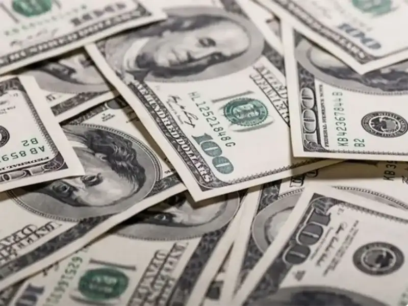 U.S. dollar bills and global currency symbols