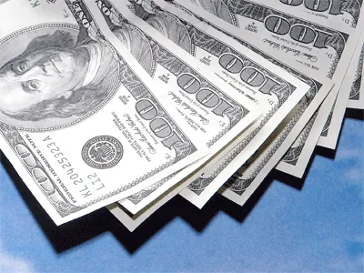 U.S. dollar bills and global currency symbols