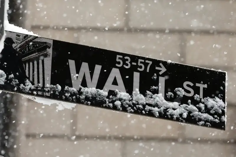 Stock market display showing Dow Jones, Nasdaq, and S&P 500 indices