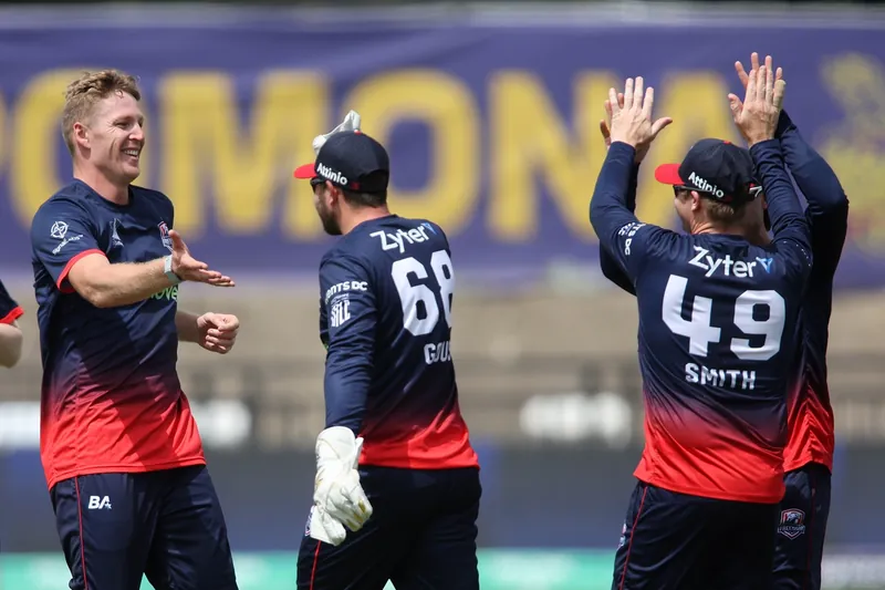 Cricket players celebrating a victory on the field