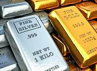 Gold and silver bars on a financial newspaper