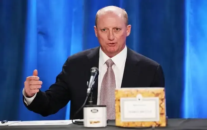 Greg Abel, CEO of Berkshire Hathaway, with Alphabet logo