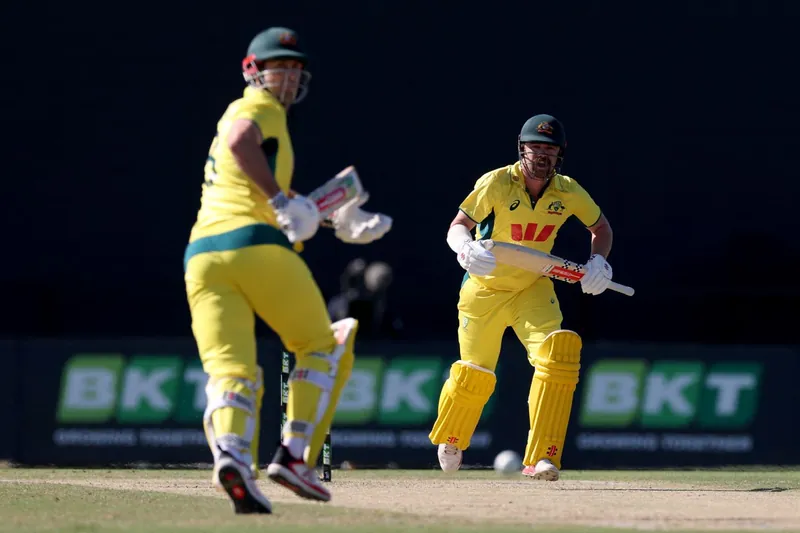 Australian cricket players in action on the field
