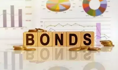 A graph depicting the rise in Indian bond yields against a backdrop of oil barrels and currency symbols.