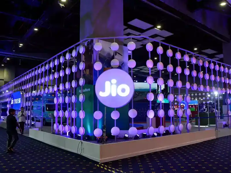 Jio Platforms logo with stock market graph in the background