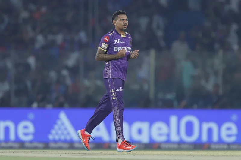 Kolkata Knight Riders players strategizing on the field during an IPL match