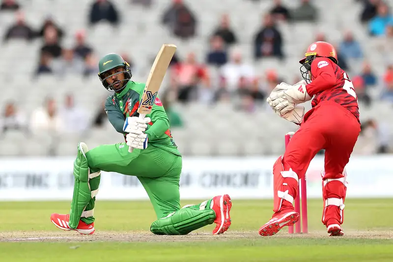 Cricket player being taken off the field on a stretcher