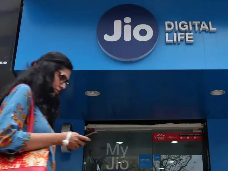 Reliance Jio logo with stock market background