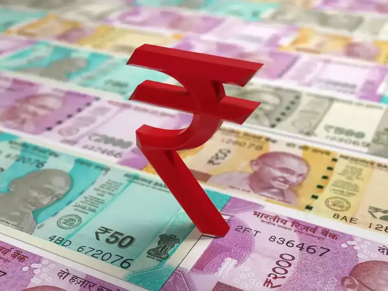 Indian rupee notes and US dollar bills