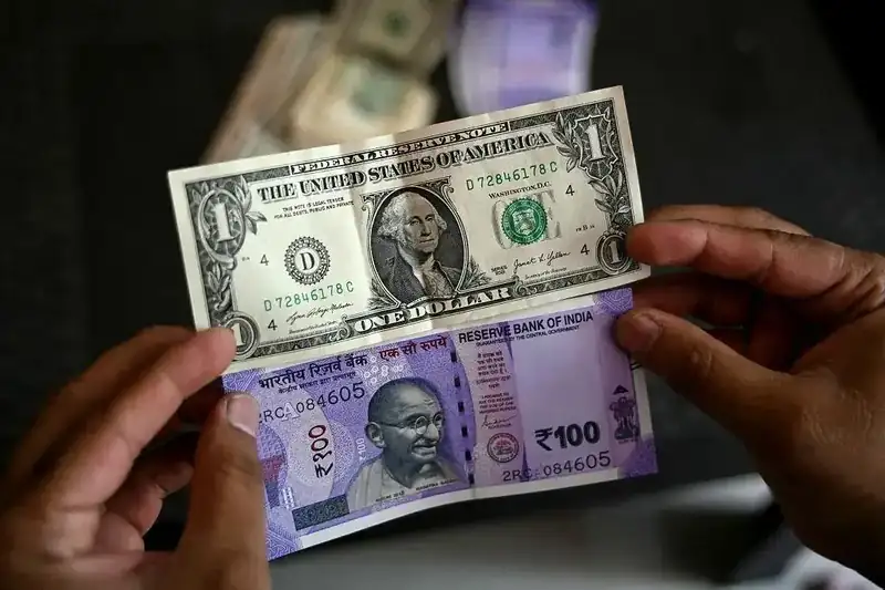 Indian rupee notes and US dollar bills