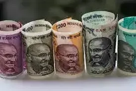 Indian rupee notes and US dollar bills