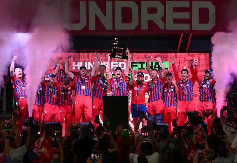 Cricket players celebrating a victory on the field