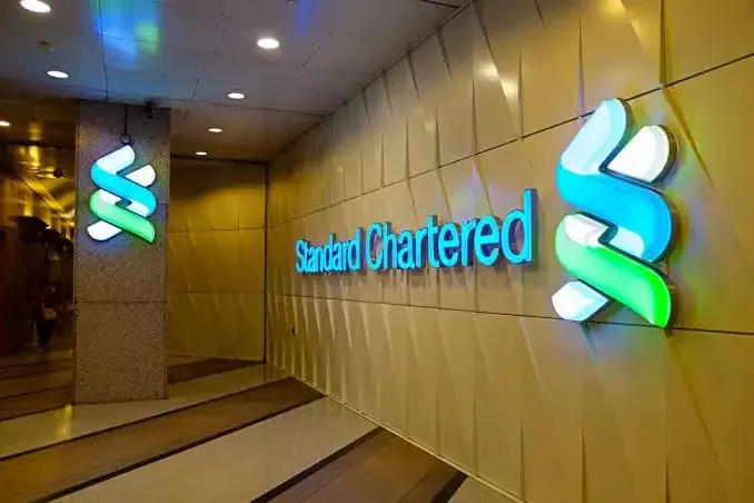 Standard Chartered and BlackRock logos with financial market background