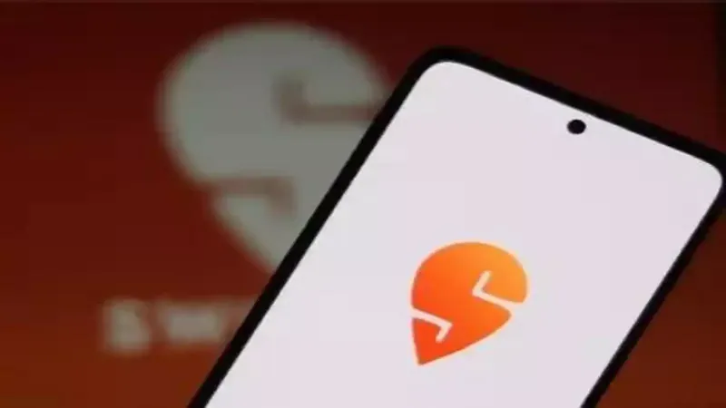 Swiggy logo on a smartphone screen with stock market data in the background
