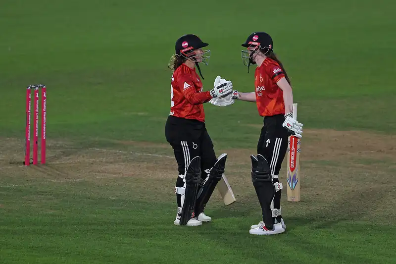 Tammy Beaumont and Sarah Bryce celebrating on the cricket field